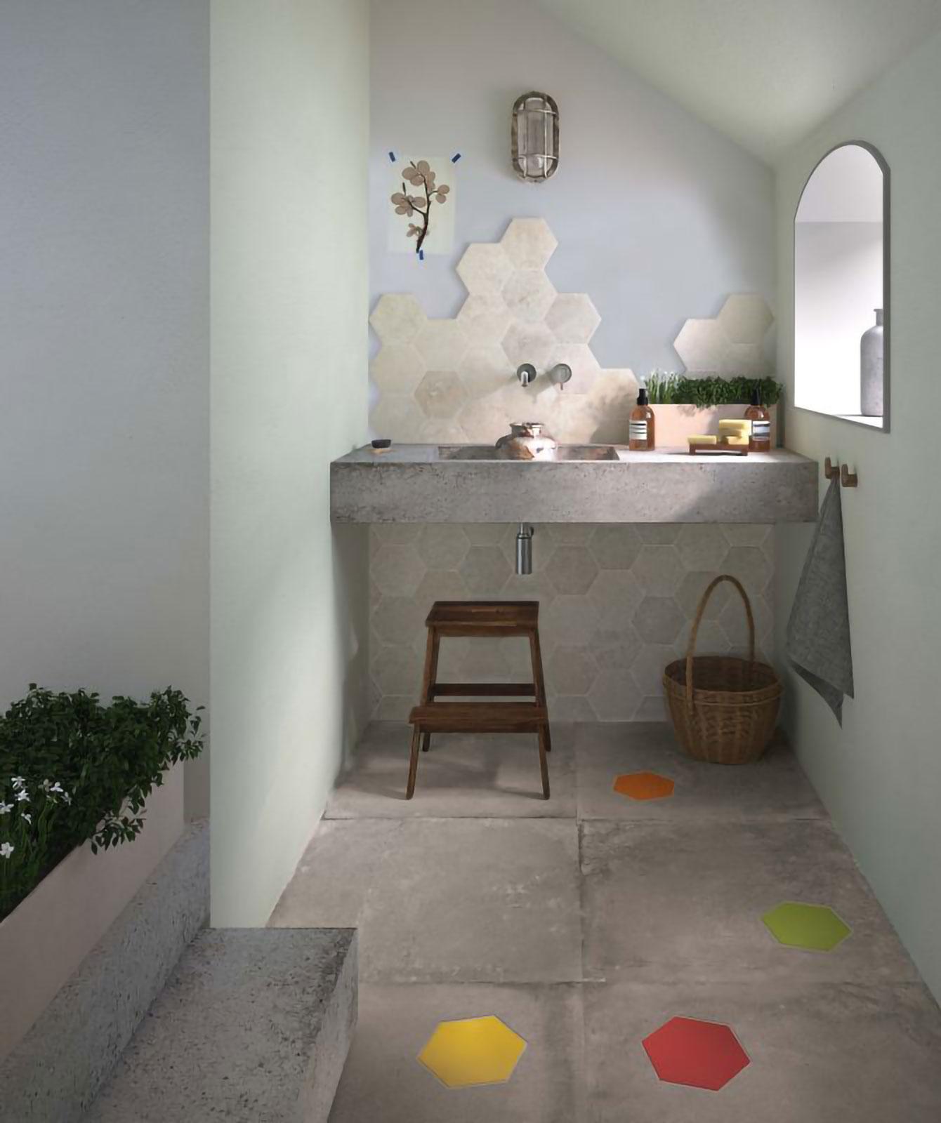 Salle de bain avec inserts hexagonaux colorés dans carreaux gris