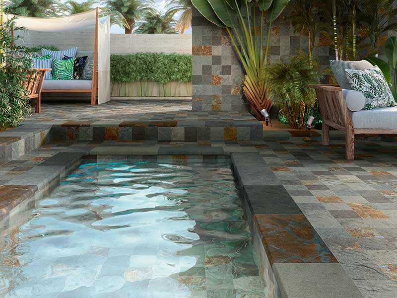 Magnifique piscine avec du carrelage effet pierre de Bali